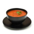 Bowl of tomato soup isolated on white background